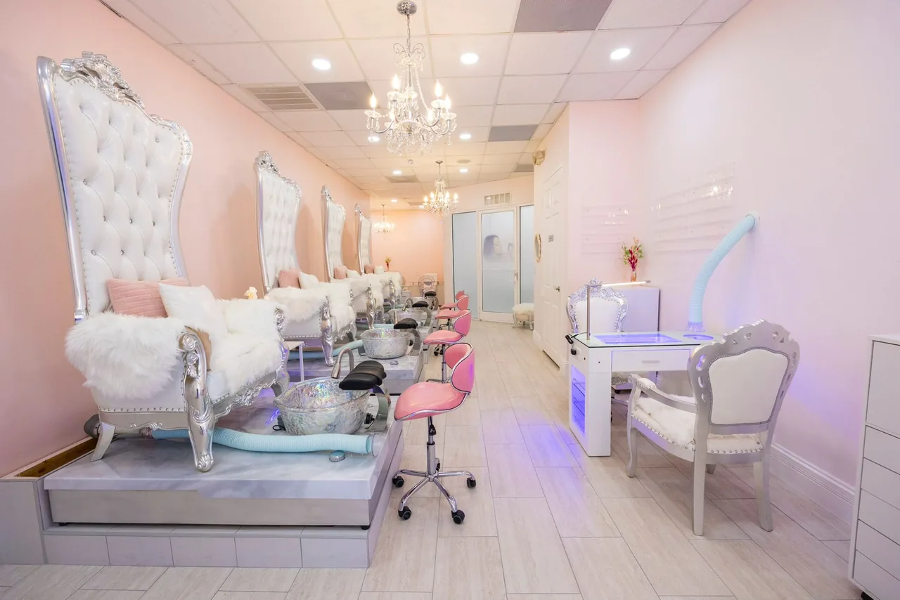 Ornate pedicure thrones under a chandelier in the nail room at The Beauties Salon